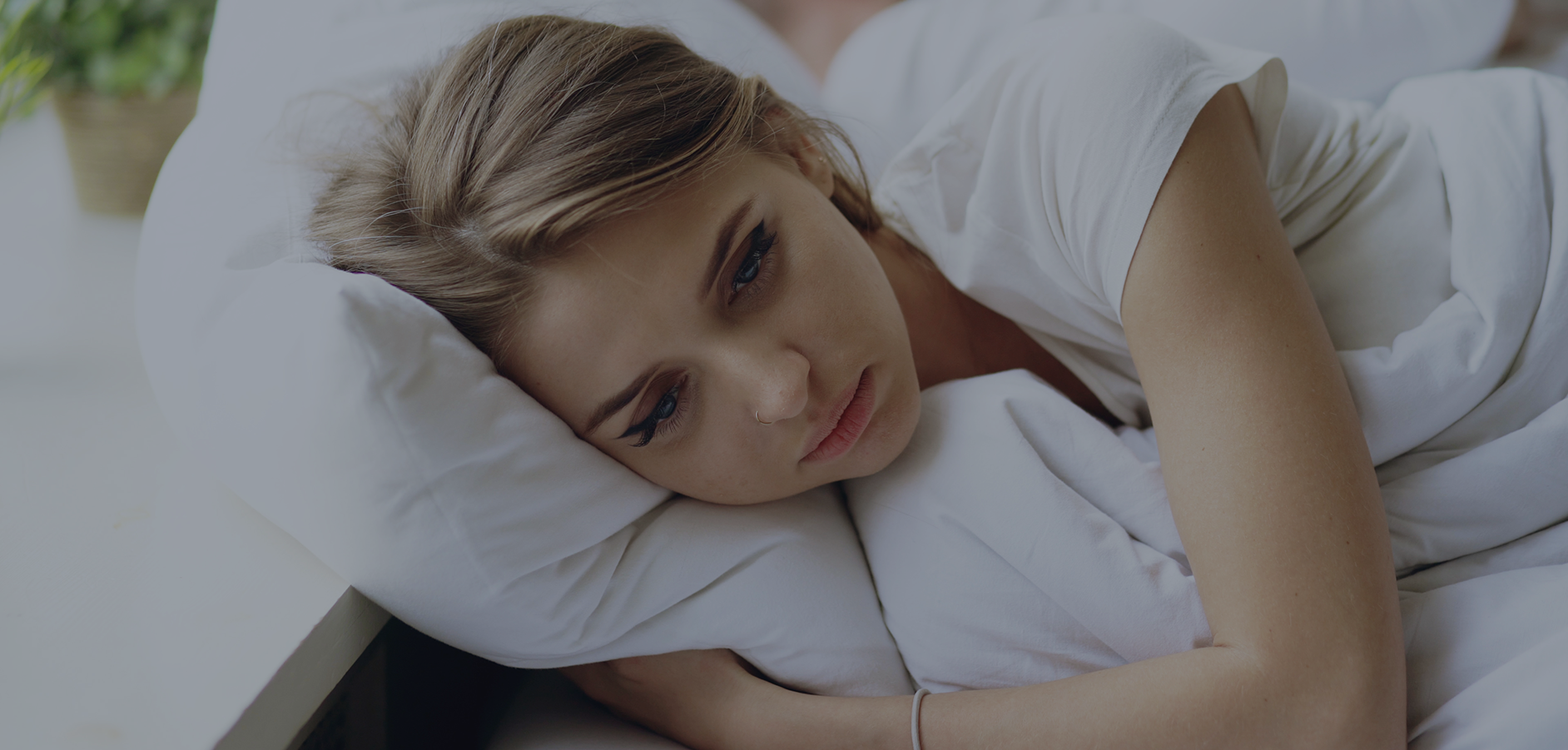 Depressed woman laying on pillow