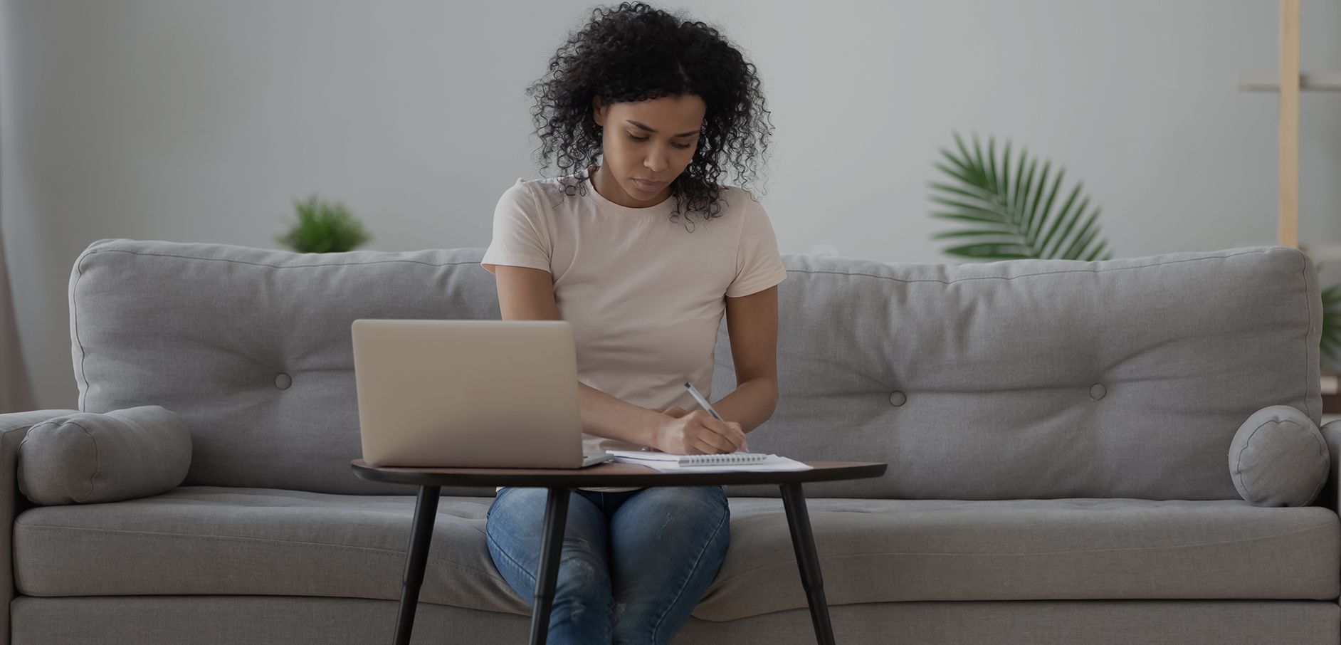 Woman working on laptop on couch