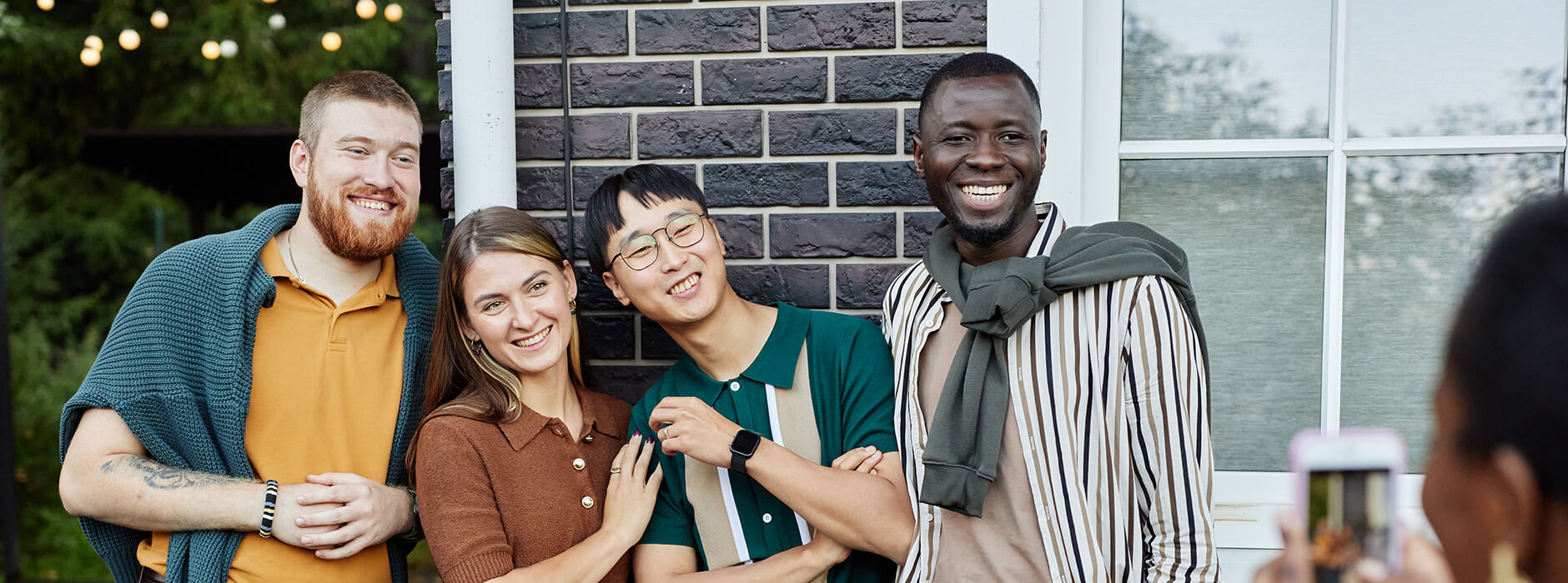 Multicultural friends standing for picture